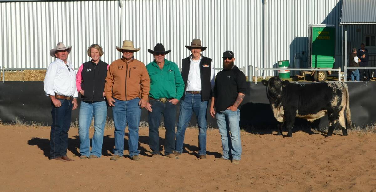Dennis Power, Amy and Justin Dickens, David Johner, Saskatchewan, Canada, David Reid and Justin Johner, with the second top priced bull who sold for $30,000.