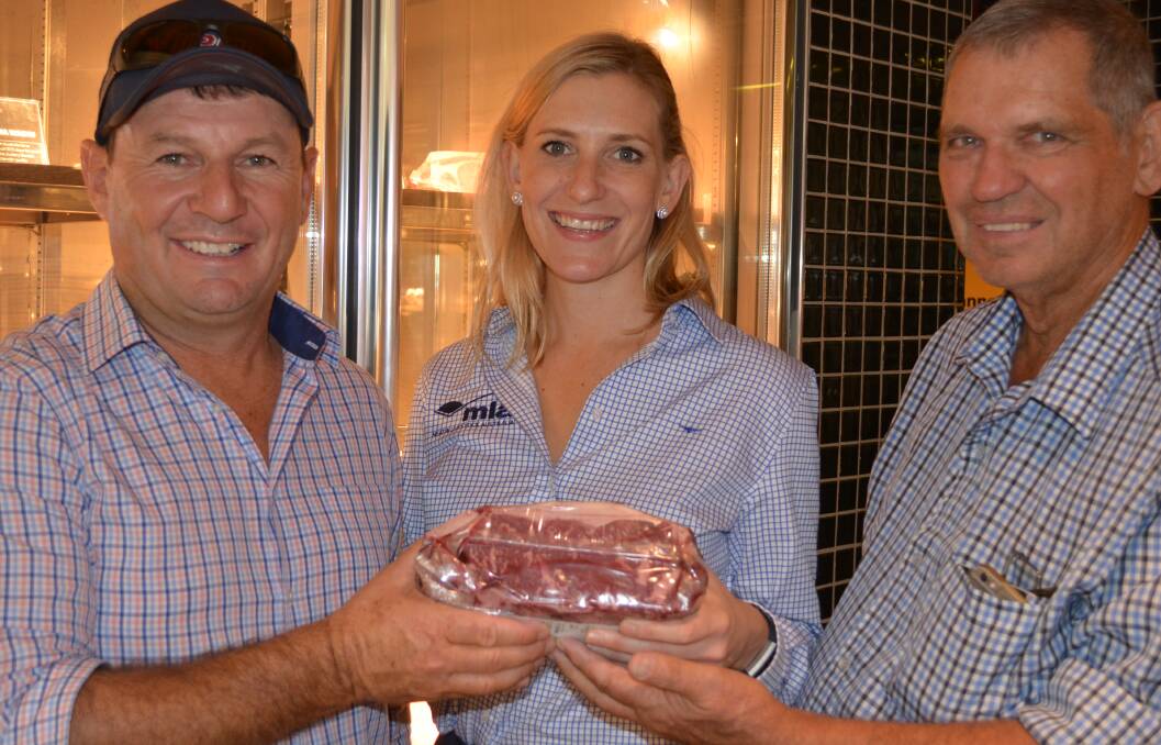 Meat and Livestock Australia's Ellen Rodgers with Australian farmers visiting Singapore with an ANZ Banking Group agribusiness delegation, James Male, "Ellamville", Yerong Creek, NSW and Adrian Tiller, Sherwood, Queensland, checking out a $170 a kilogram cut of Australian Wagyu-cross beef in the Honest Bee supermarket.