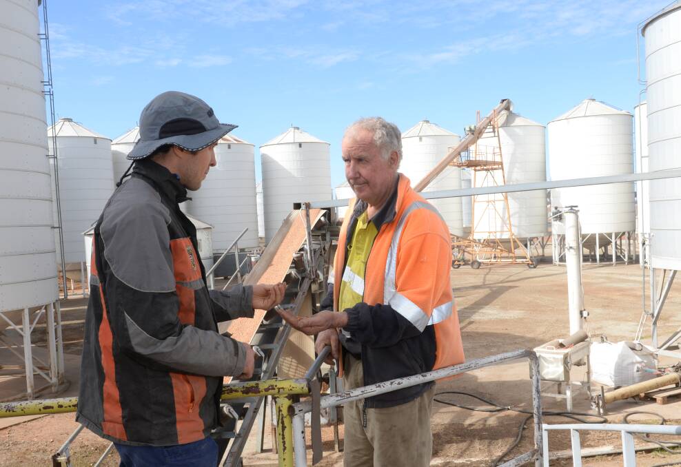 Buckwheat Enterprises, managing director, Geoff Brown (right), unloading stockfeed from Western Australia, with son Aden, at the company's Central West NSW rail site near Parkes.