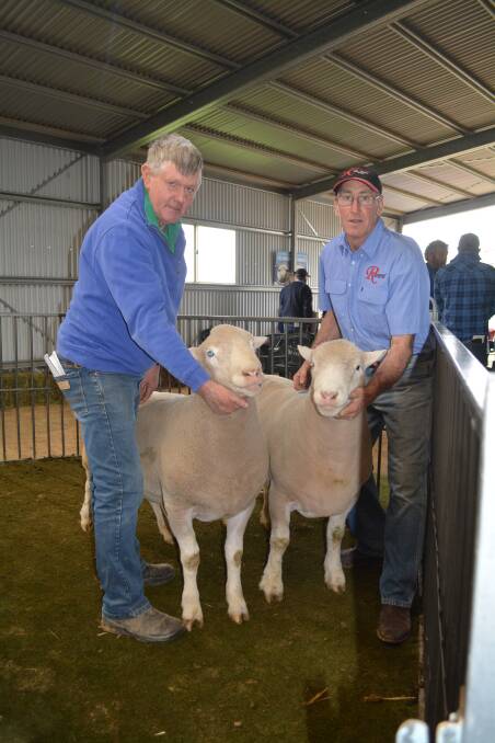 Brian Anderson, Jessmondeen Pastoral Company, Crookwell, with David Sinsbury of Rosewood Poll Dorsets and the two $1500 top-priced Poll Dorset rams. 