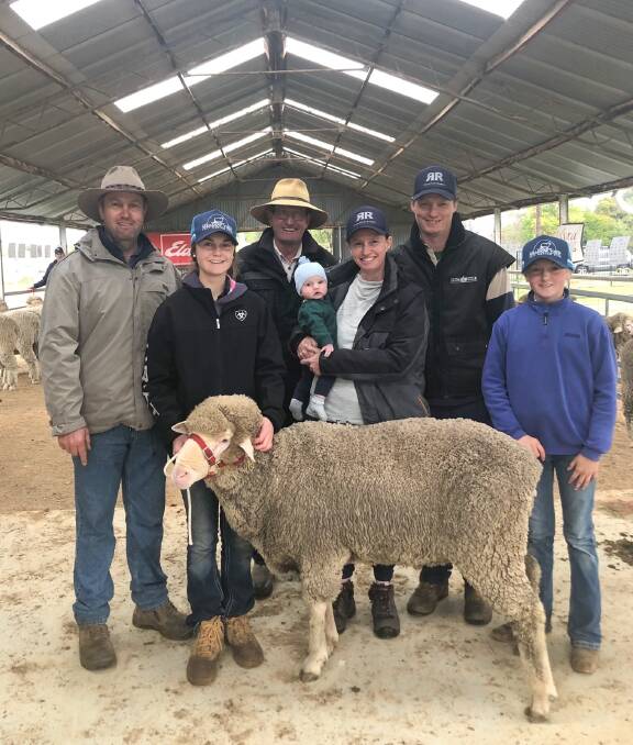 The top ram with Simon, Layla and Evie (right) Bahr, Meadow View, Henty, and buyers Ross Friedrich, Diana and Justin Carter with son Jimmy, 1. Photo: Supplied 