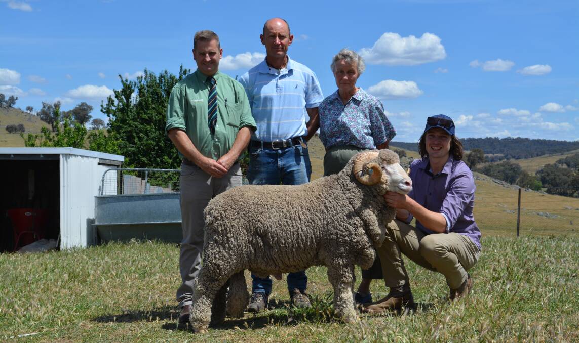 Landmark auctioneer, Rick Power, purchasers of the top price ram, Dr Richard Geeve and his mother, Bronwyn Geeve, Walcha, and Sam Picker holding the $5750 sale topper. 
