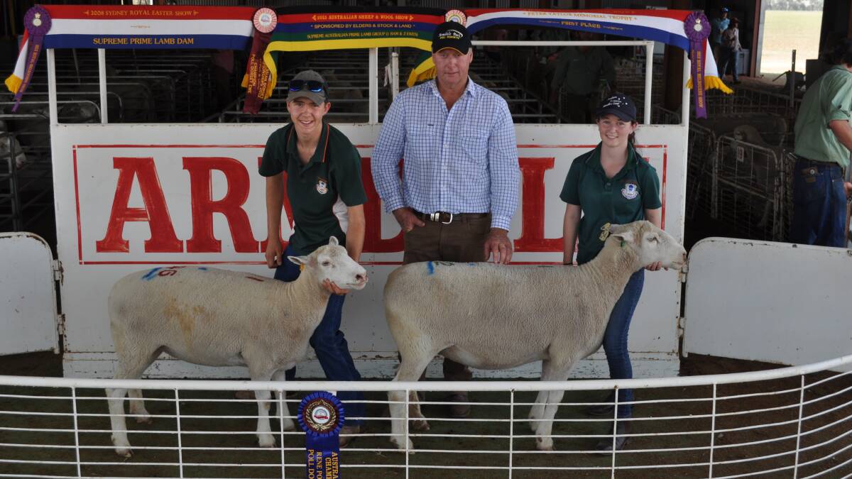 Garry Armstrong (centre) and The Riverina Anglican College students, Jacob Kerrisk and Monique McKinley, with two of the ten ewes the school purchased last Friday.