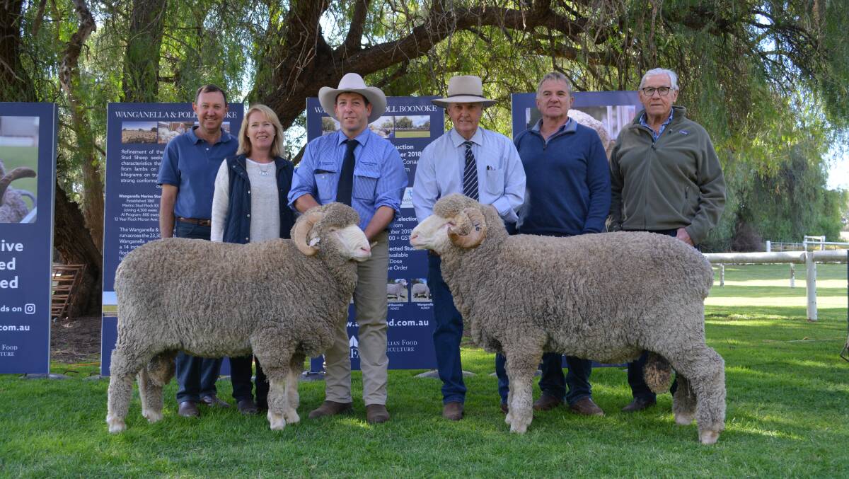 Gerald and Jodie Mullighan, with the $16,000 ram held by Shannon Mitchell, and the $18,000 Merino with Chris Bowman, buyer Michael Keatley, and Colin Bell. 