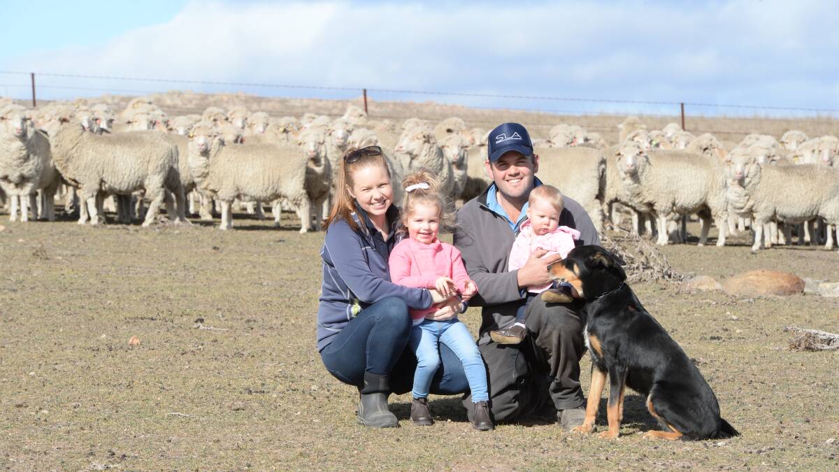 Virbac Australia's Multimin Performance Ready Challenge NSW finalist, Alex Willson, Tarago, with his wife, Steph and daughters, Lara, 2.5, and Sophie, seven-months, pictured with five-year-old Merino ewes due to lamb in September.