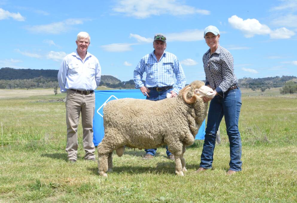 Auctioneer John Croake of selling agents AWN Livestock with first-time buyer and purchaser of the $4250 top-priced ram Shane Moss of Wollar and Bec Cox of Bocoble Merinos, Mudgee. 