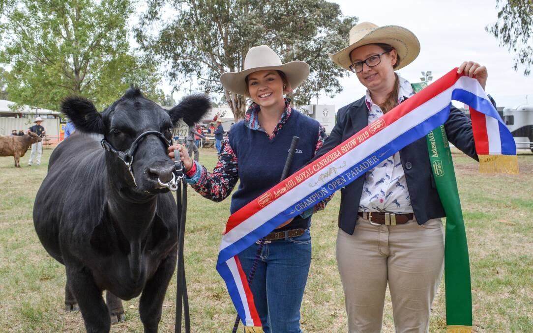 The open beef cattle paraders champion Casey Halliday, J & C Angus, Wildes Meadow, with ribbon presenter Sarah Hanlon, Cootamundra.  