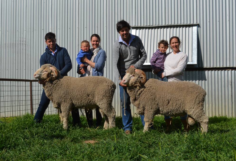 Koonwarra worker Victor Coble, with volume and top-priced buyers Bob, 18 months, and Emma Webb, Yass, Koonwarra stud principal, Jono Merriman, and his wife Anna and son Digby, who celebrated his fourth birthday on sale day. 