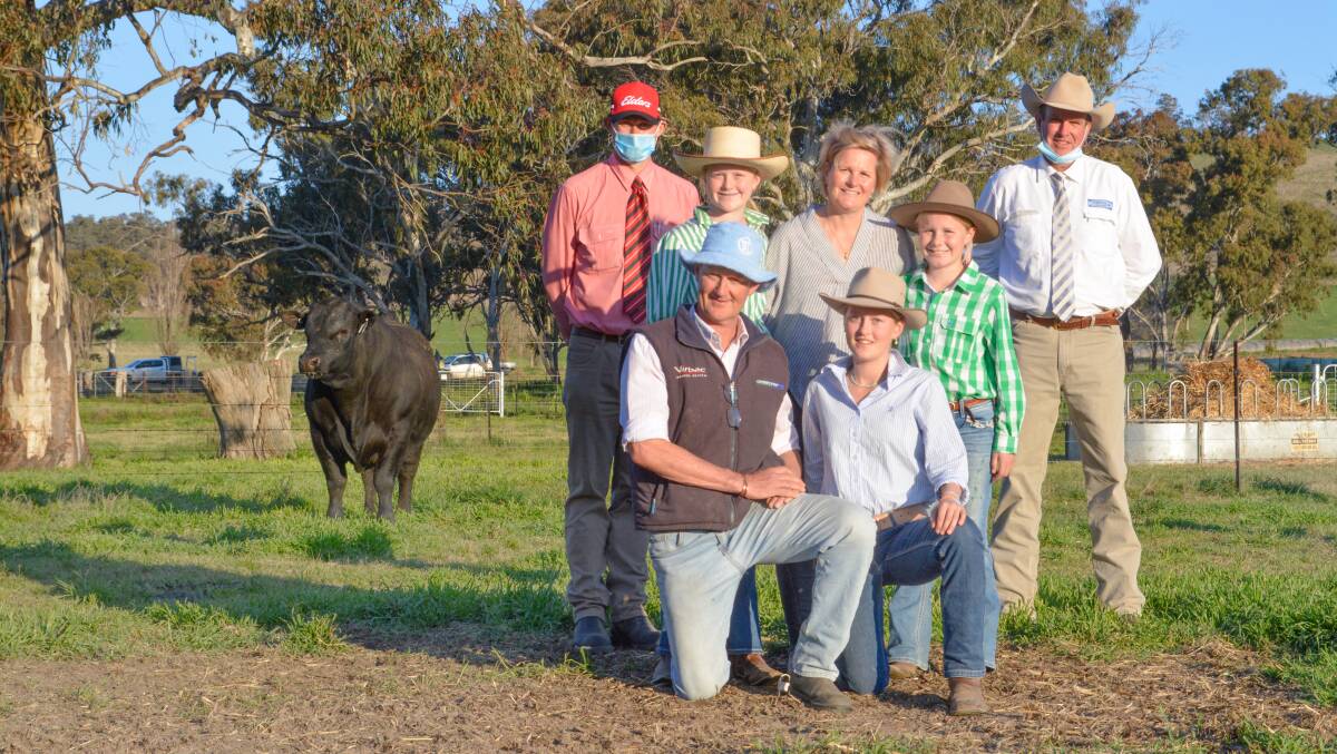 The $280,000 Australian Angus record top-priced bull with Elders agent Andrew Bickford, Bathurst, auctioneer Paul Dooley, Tamworth and Millah Murrah's Ross and Dimity Thompson and their daughters Millie, Olivia and Twiggy.
