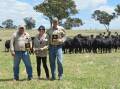 Manager Claydon Butt with Lynne and Craig Turnbull of Shepstone Park, Jugiong, with their array of trophies and their spring-calving Angus females.