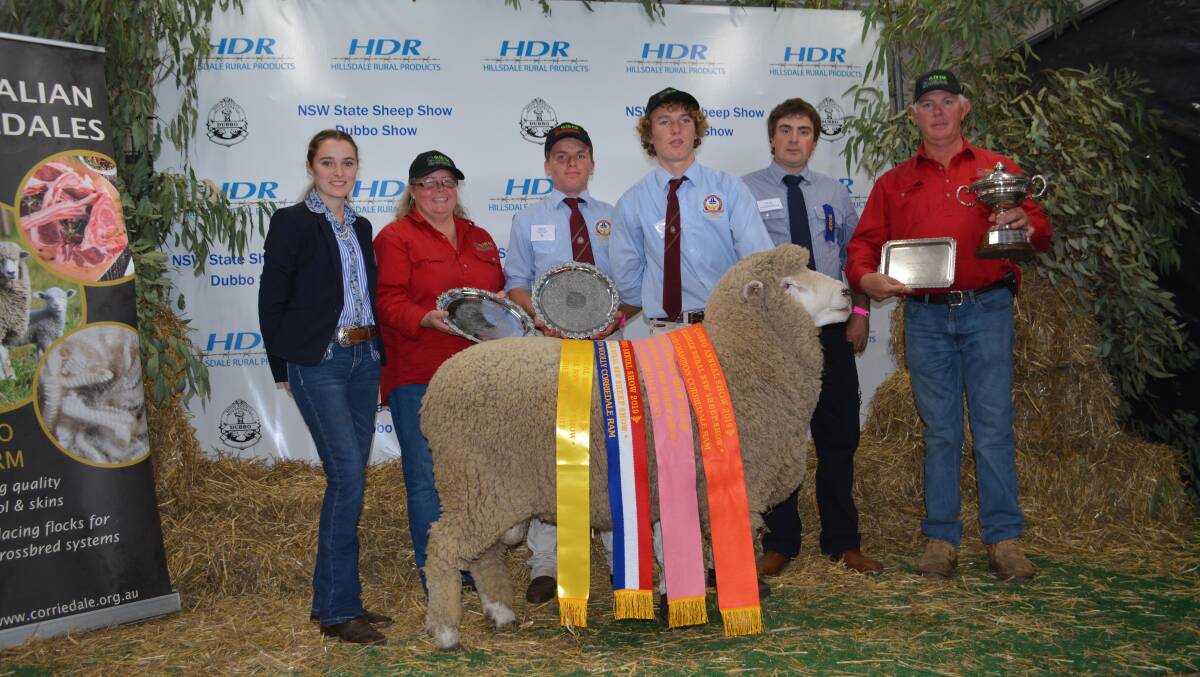 The supreme exhibit of the Corriedale feature show was Glen Esk stud's grand champion ram, and best Corriedale head winner, Glen Esk Junior 029/17. Pictured with judges, owners, and Trinity Catholic College students. 