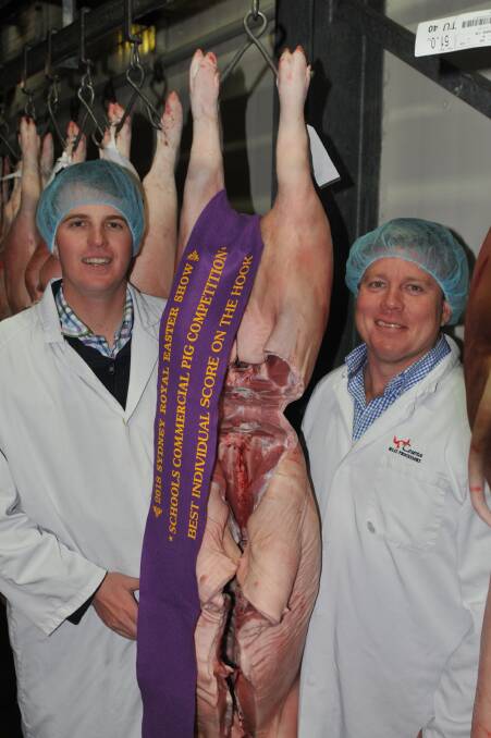 Charles Sturt University Wagga Wagga judges, Jake Bourlet and Michael Campbell, with the Wollemi College best individual carcase at Breakout River Meats, Cowra. 