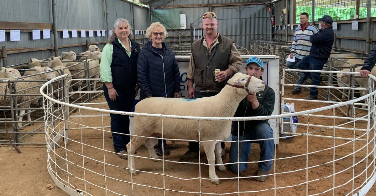 The Mark Hughes Foundation charity Poll Dorset ram which sold for the sale top of $4400 with vendors Lyn and Scott (kneeling) Madden, and Janelle and James Tinham, Yarra. Photo: Kellie Arnell 