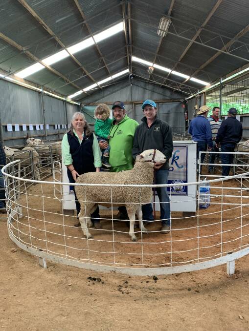 The $4200 top-priced Border Leicester with Lyn Madden, Glenwood Park, and buyers Roy and Nick Hearn, and Scott Madden, Glenwood Park stud. 