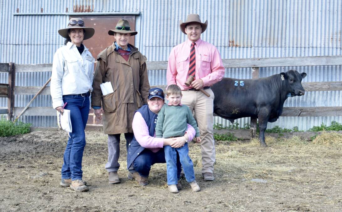 The $30,000 top-priced bull with Netta Holmes Lee, Noonee, Larras Lee, Jim Bowman and Kate Bowman and her son Archie, 3, Merotherie, Dunedoo, and auctioneer Lincoln McKinlay, Elders stud stock, Inverell. 