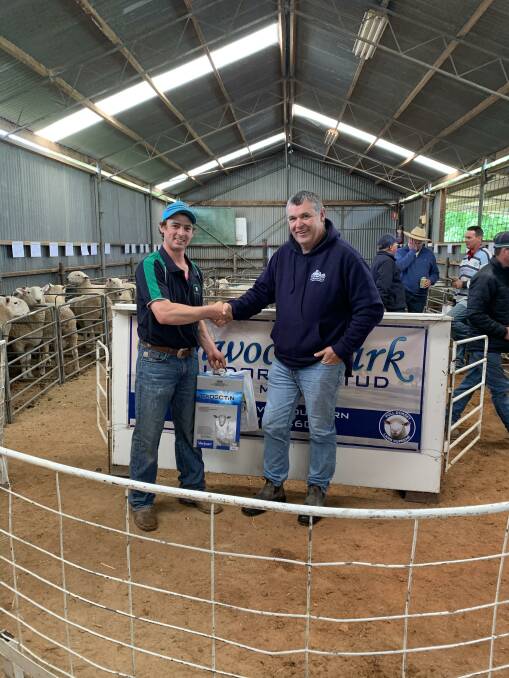 Glenwood Park's Scott Madden shakes the hand of the largest volume buyer Andy Divall of Narrumbulla Pastoral Company, Goulburn. 