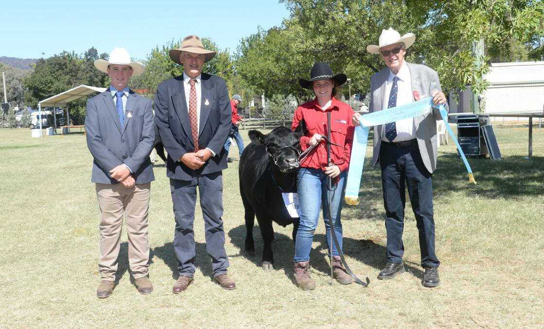 The Ausline supreme exhibit held by Claire Reid, Canberra, with associate judge Hamish Maclure, Tarcutta, judge Peter Collins, Tennyson, Victoria, and ribbon presenter Phil Bower. 