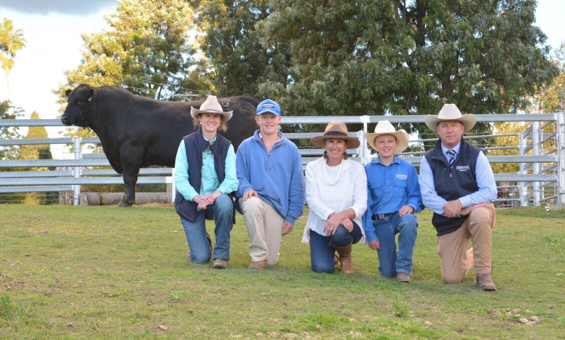 Jo (centre) and Sinclair (right) Munro with their children Arabella, 17, Digby, 15, and Barnaby, 13, and the $40,000 second top-priced bull. 