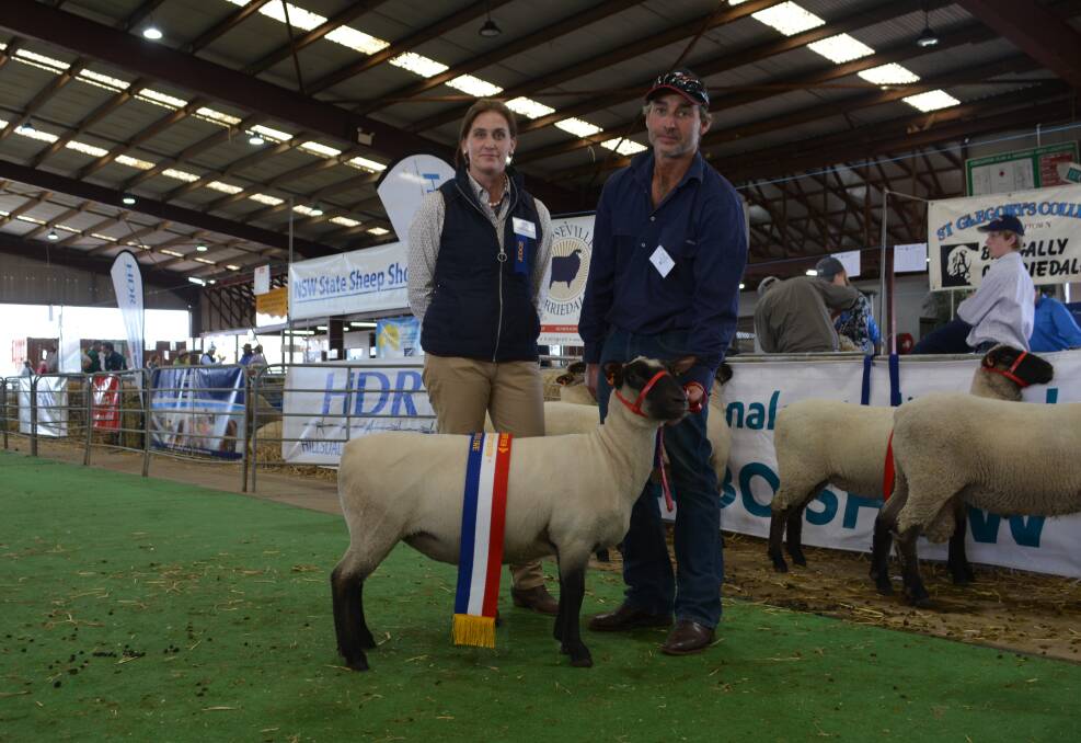 Judge Deva Weitman of Blue Rock Suffolk stud, Romsey, Victoria, with the champion South Suffolk ewe exhibited by the Gotta Rock stud, and held by stud owner Steve Conley, Yerong Creek. 