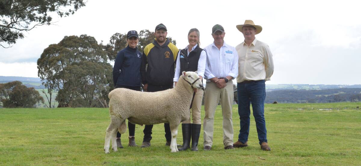 Buyers Sophie Lynch and Adam Selmes of Crookwell, with Kylie and Scott Anderson of Talkook Border Leicester stud, Crookwell, auctioneer Greg Anderson of selling agents MD and JJ Anderson Pty Ltd, Crookwell, and the $6000 top-priced ram. 