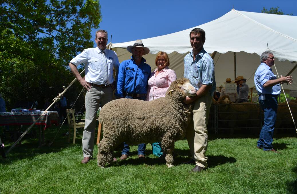 Auctioneer Paul Dooley with purchasers of the $6500 sale-topper Robert Cox and Paivi Torronen, Avondale, Manildra, and Grogansworth co-principal George Henderson, Bowning, holding the ram. 