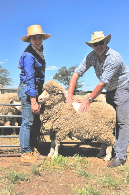 High performing ewe 160337 with MerinoLink MLP site manager Lexi Cesnik and Geoff Lindon of Australian Wool Innovation (AWI). Photo: supplied 