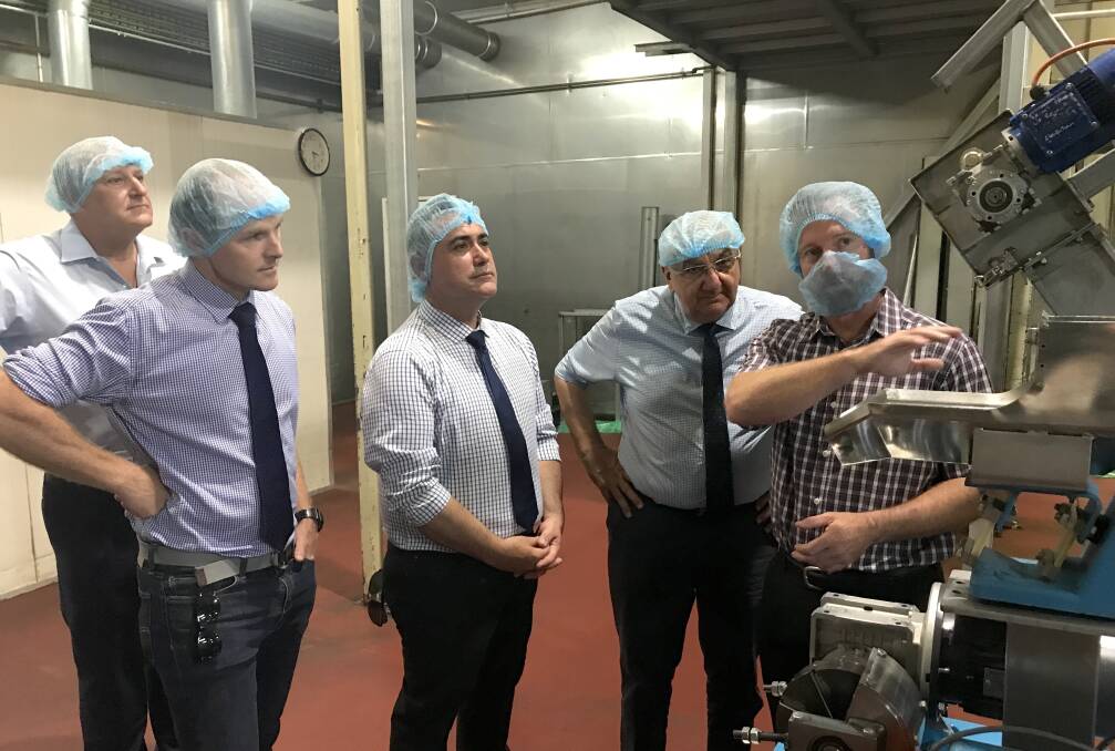 Macadamia Processing Company general manager Steven Lee shows Deputy Premier John Barilaro around the co-op's Alphadale plant this week. An extra 450 tonnes of nuts will now be produced each year thanks to a low-interest co-op loan. Photo supplied. 