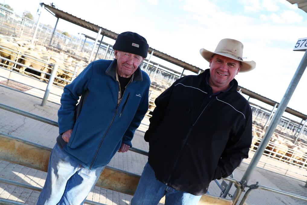 EYE ON THE MARKET: A file image of Philip Curtis and livestock agent Aaron Mackay at Wagga sheep and lamb sale. Picture: Emma Hillier