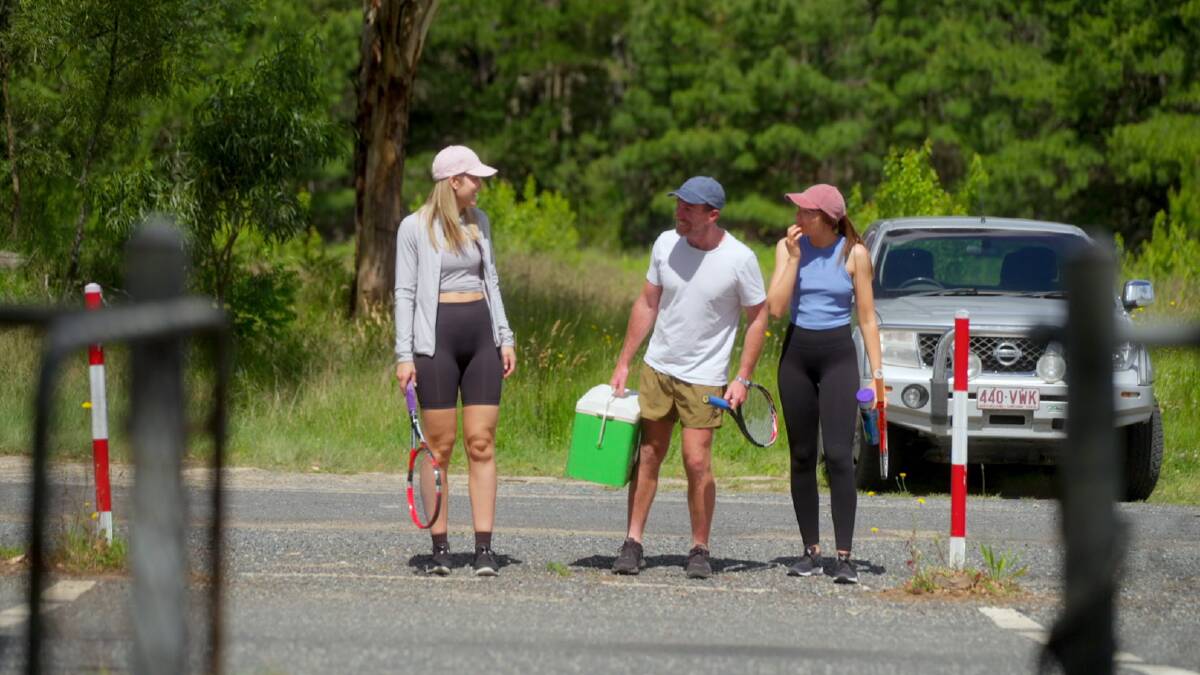 Farmer David takes Emma and Emily for a hit of tennis. Picture by Channel 7