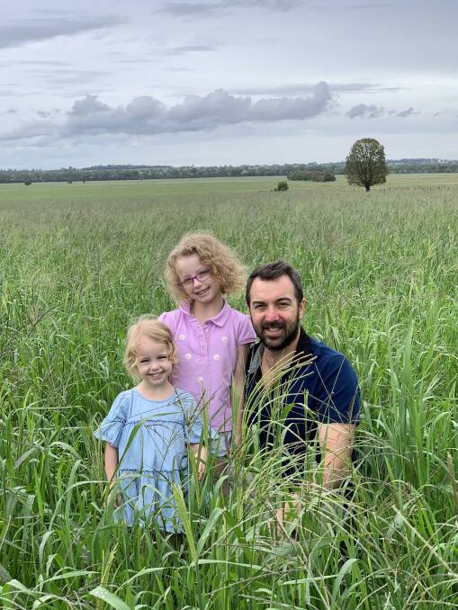 Andrew Freebairn with daughters Georgia and Mia, check the same pasture as above just over four weeks post the beginning of drought-breaking rains.