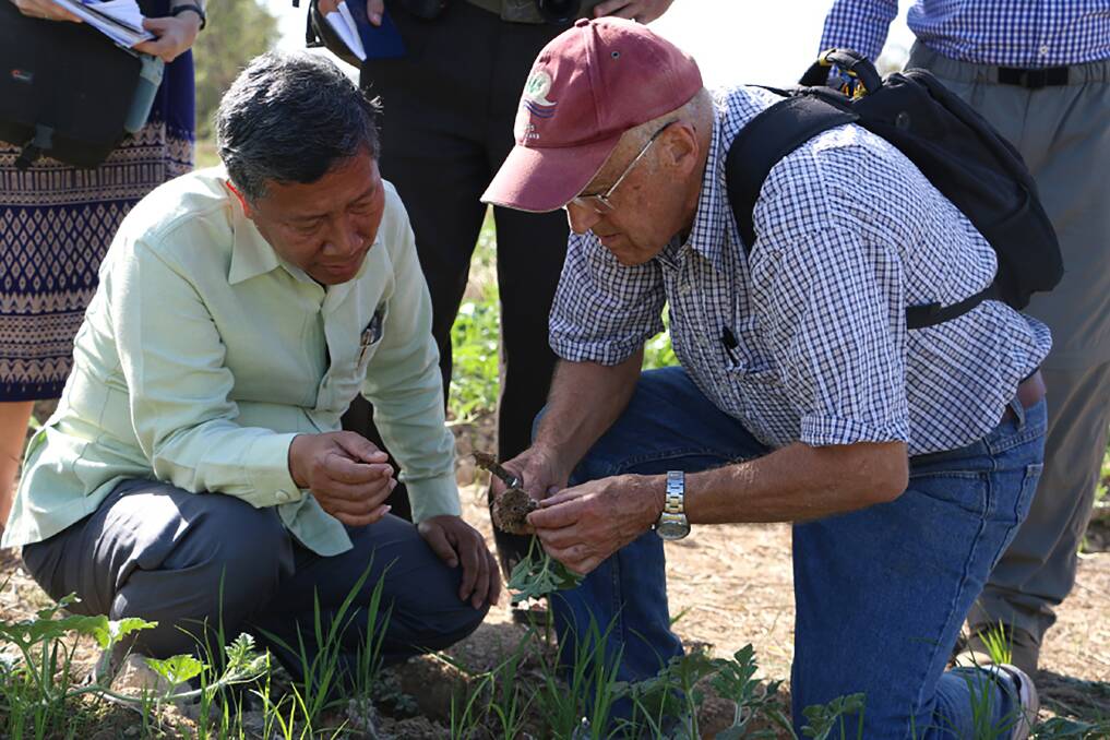 Professor Lester Burgess speaks with the Head of Mounlapamok District in Champasak Province, Laos, about Fusarium wilt of watermelons in 2015. Picture supplied