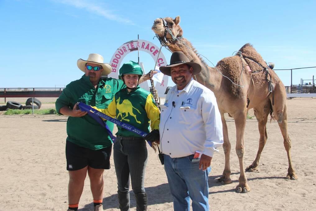 Trevor "Colgate" Stewart (right) presents the blue ribbon to one of the winners at Bedourie Camel Races. Photo: Shelly Dillon.