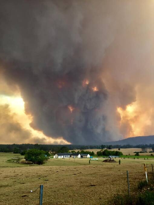 A bushfire burns north west of Nowra on the south coast. This photo was taken on the day it crossed the Shoalhaven River. Photo by Hayley Warden