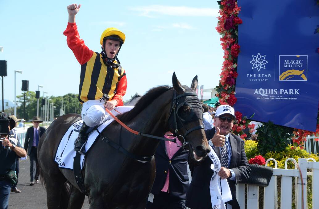 Excited Queensland breeder and racegoer, Scott McAlpine, leads Boomsara back to scale (with Sydney based hoop Tim Clark aboard) after their win in the $1m Magic Millions Gold Coast Guineas on Saturday. Photo Virginia Harvey