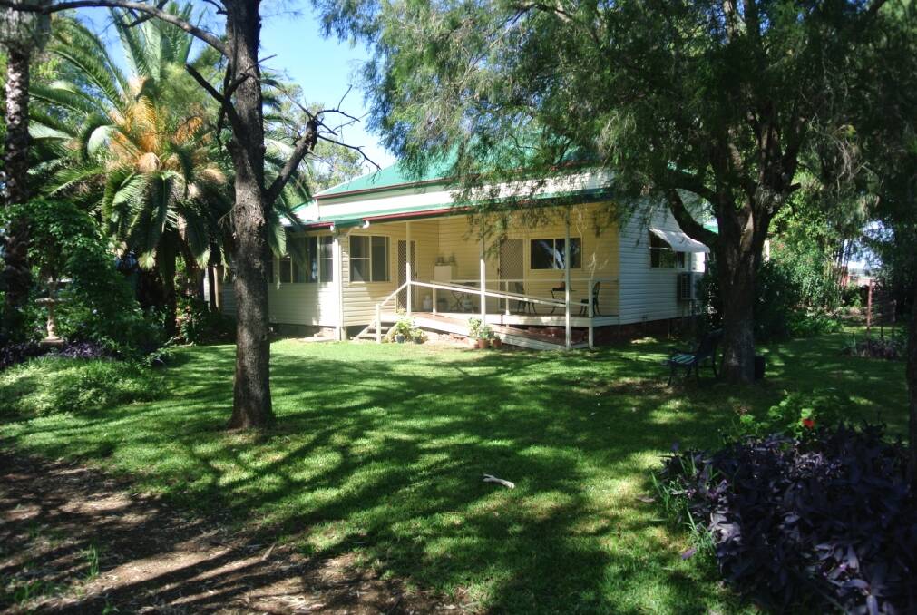 Set amid established lawns and mature trees, the attractive, air-conditioned, weatherboard home boasts a modern kitchen, open-plan living/dining area and new bathroom.