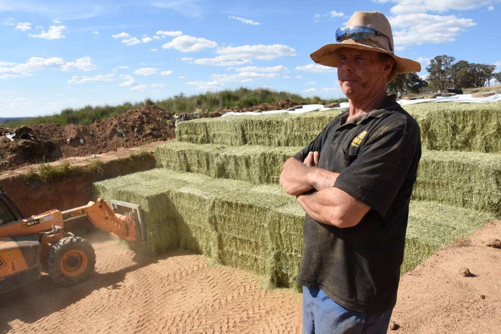 Duncan Clowes stands next to his silage pit on "Valdemar", just outside of Millthorpe, as it is recharged. 