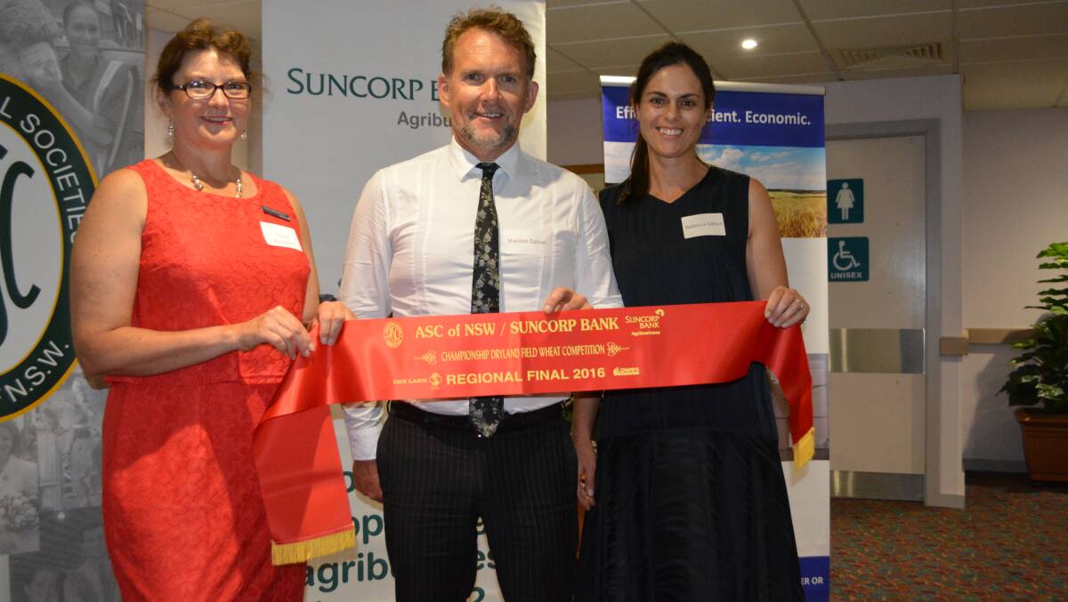 Tracy Blackburn, Suncorp, Dubbo, presents the sash for second place in the western region wheat competition to Sheldon and Rebecca Dalton early last year. 