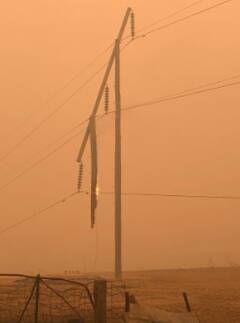 A timber power pole on line 993 burns. Photo: Transgrid