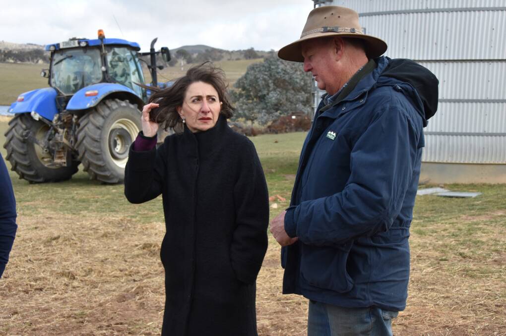 Premier Gladys Berejiklian speaks with Cliff Kelly at "Ferndale", Newbridge, on Monday morning after announcing the drought relief package.