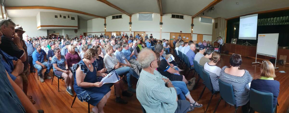 People listen as the government outlines its plans to "regulate" the mouth of Yanco Creek. There is little trust of government intentions.