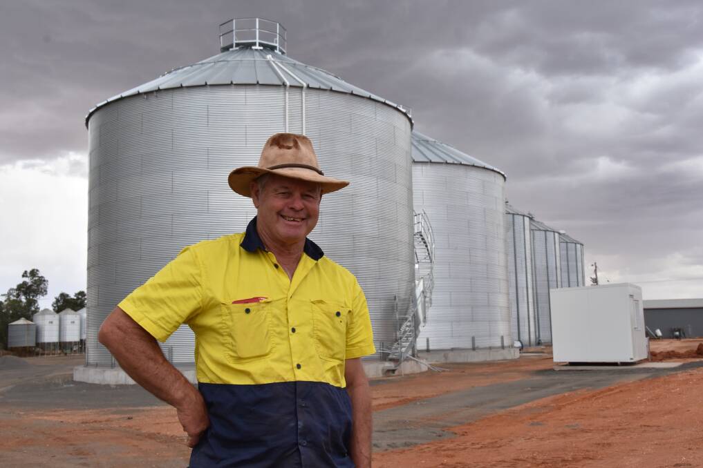 Trevor Gray with the new silos at Runnemede, Merriwagga.