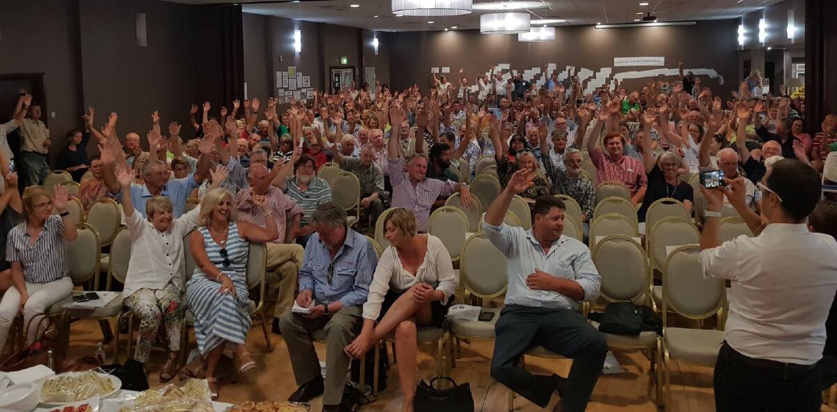 A vast show of hands from the crowd at Coonamble Bowls Club passes 'The Coonamble Declaration'.