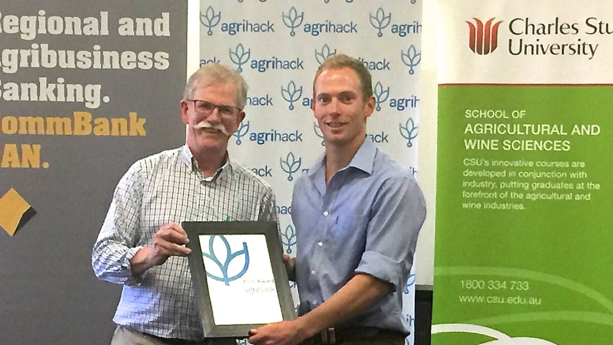 Professor John Mawson presenting Matt Champness, third year agriculture student, with his prize for 'Best Pitch' and $500