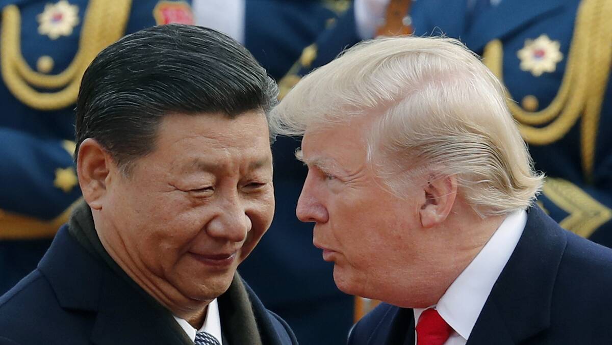 US President Donald Trump chats with Chinese President Xi Jinping during a welcome ceremony at the Great Hall of the People in Beijing last year. Photo - Andy Wong.