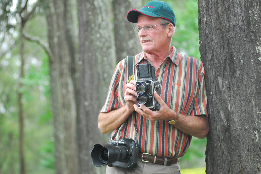 Michael Petey, photographer for The Land from 1980 to 2015, pictured at the North Richmond office and printing site in 2010. He is holding a Mamiya C220, with a digital Nikon camera over his shoulder.