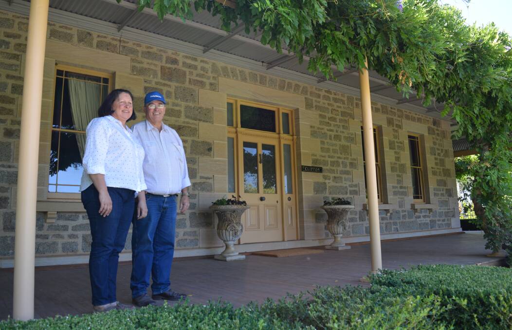 Rebecca and David McMillan on the verandah at Clifton, Young. The house was built in 1890 and has been renovated as a function centre and farm stay.