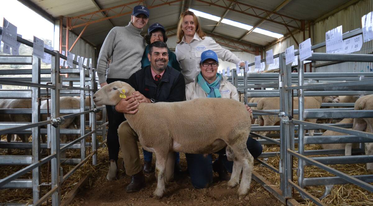 Harriett Joseph, Orange, and Margaret Finnane, Orange, representing the Torie Finnane Foundation, with Julia Jackson and Kirrily Rourke, both of Coronga White Suffolks, Orange, auctioneer Marty Simmons, Elders, holding the ram through which $1500 was raised for the foundation.