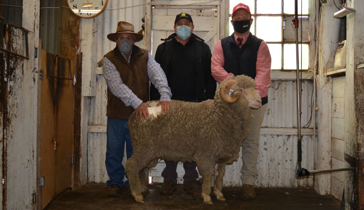 Vendor Peter Moore, Blink Bonnie Merinos, Tarana, with buyer Andrew Green, Clear Hills Pastoral, Boorowa, Jesse Gauci, Edlers Bathurst, and one of the $5200 rams.