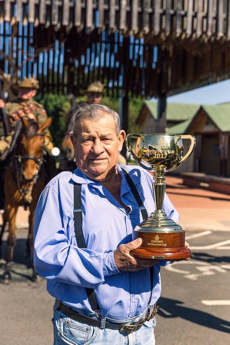 Champion: A recent picture of Tom Lockie holding the Melbourne Cup during its 2017 visit to Barcaldine. Photo supplied.