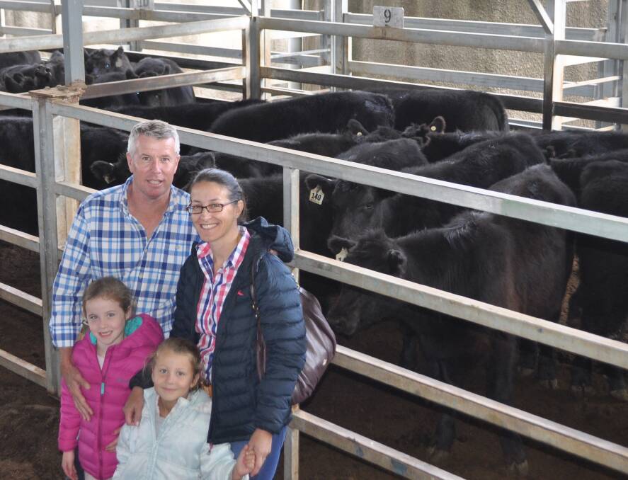 Adam and Sara Hughes with their daughter Sophie (7) and Hayley (5) from "Merryangledre", Mudgee, sold their 11 Angus steers for $800.